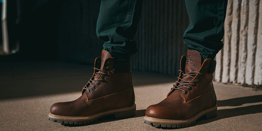 close up view of a person wearing a pair of brown Timberland boots